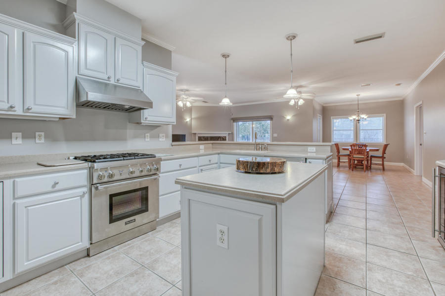 377 Ridge Road Santa Rosa Beach, FL 32459 - Photo 4 of 46 a kitchen with a stove cabinets and chairs