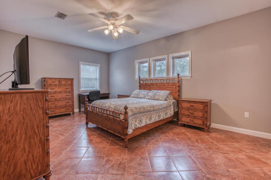 377 Ridge Road Santa Rosa Beach, FL 32459 - Photo 8 of 46 a bedroom with a bed and a chandelier