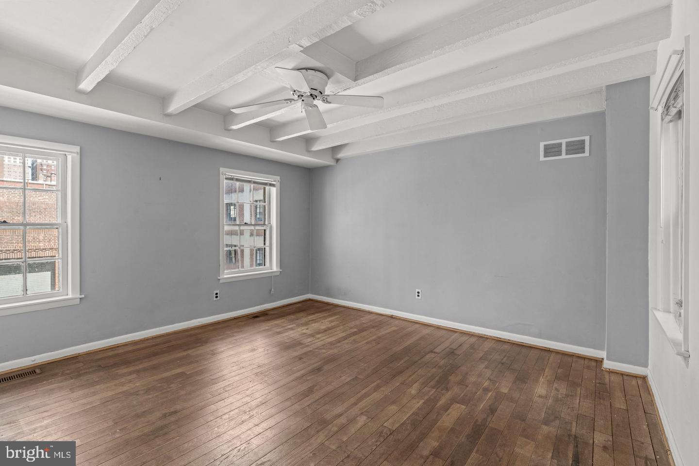 1314 Addison Street Philadelphia, PA 19147 - Photo 16 of 21 a view of an empty room with wooden floor and a window
