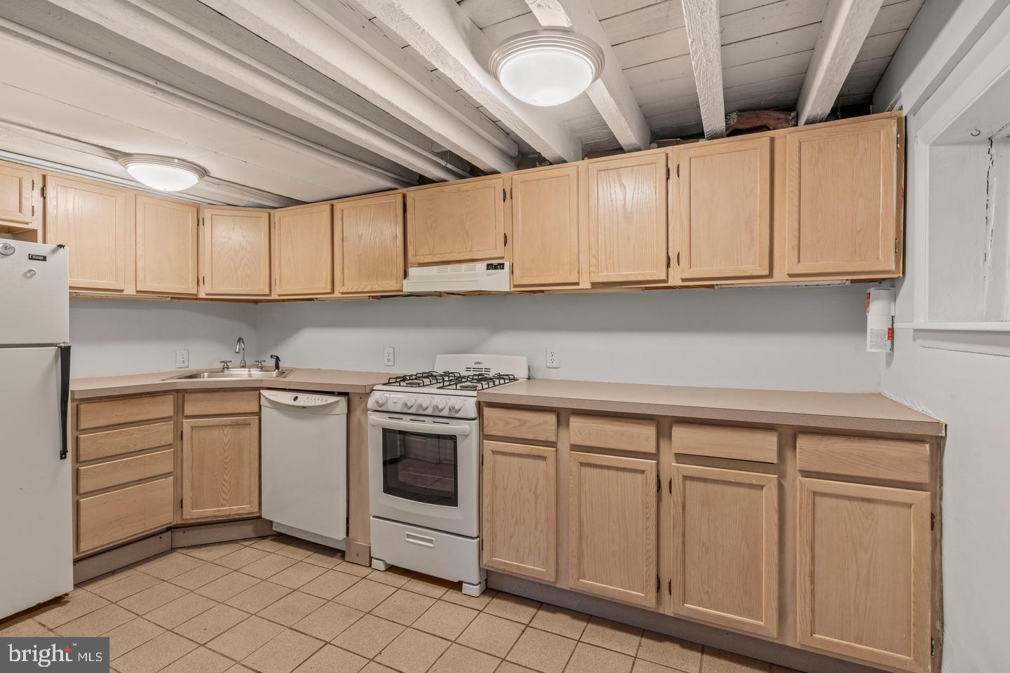 1314 Addison Street Philadelphia, PA 19147 - Photo 6 of 21 a kitchen with white cabinets and white appliances