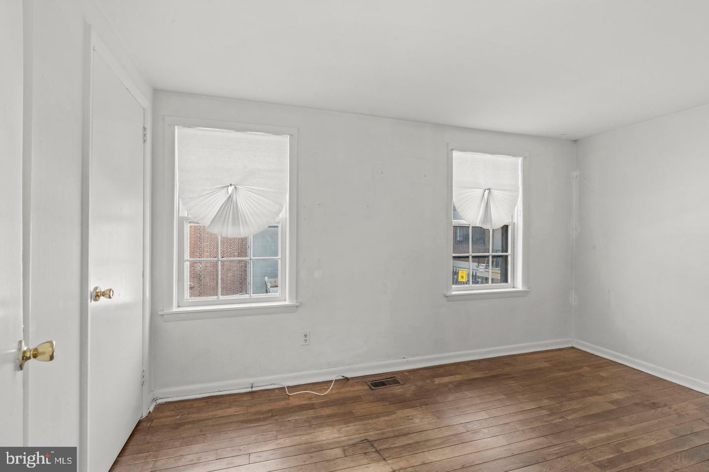1314 Addison Street Philadelphia, PA 19147 - Photo 9 of 21 an empty room with wooden floor and windows