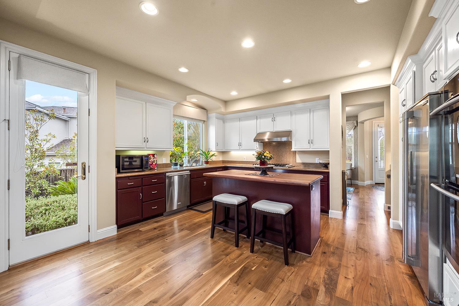 3696 Newbury Court Santa Rosa, CA 95404 - Photo 13 of 59 a kitchen with stainless steel appliances granite countertop a refrigerator a sink dishwasher a stove and a refrigerator with wooden floor