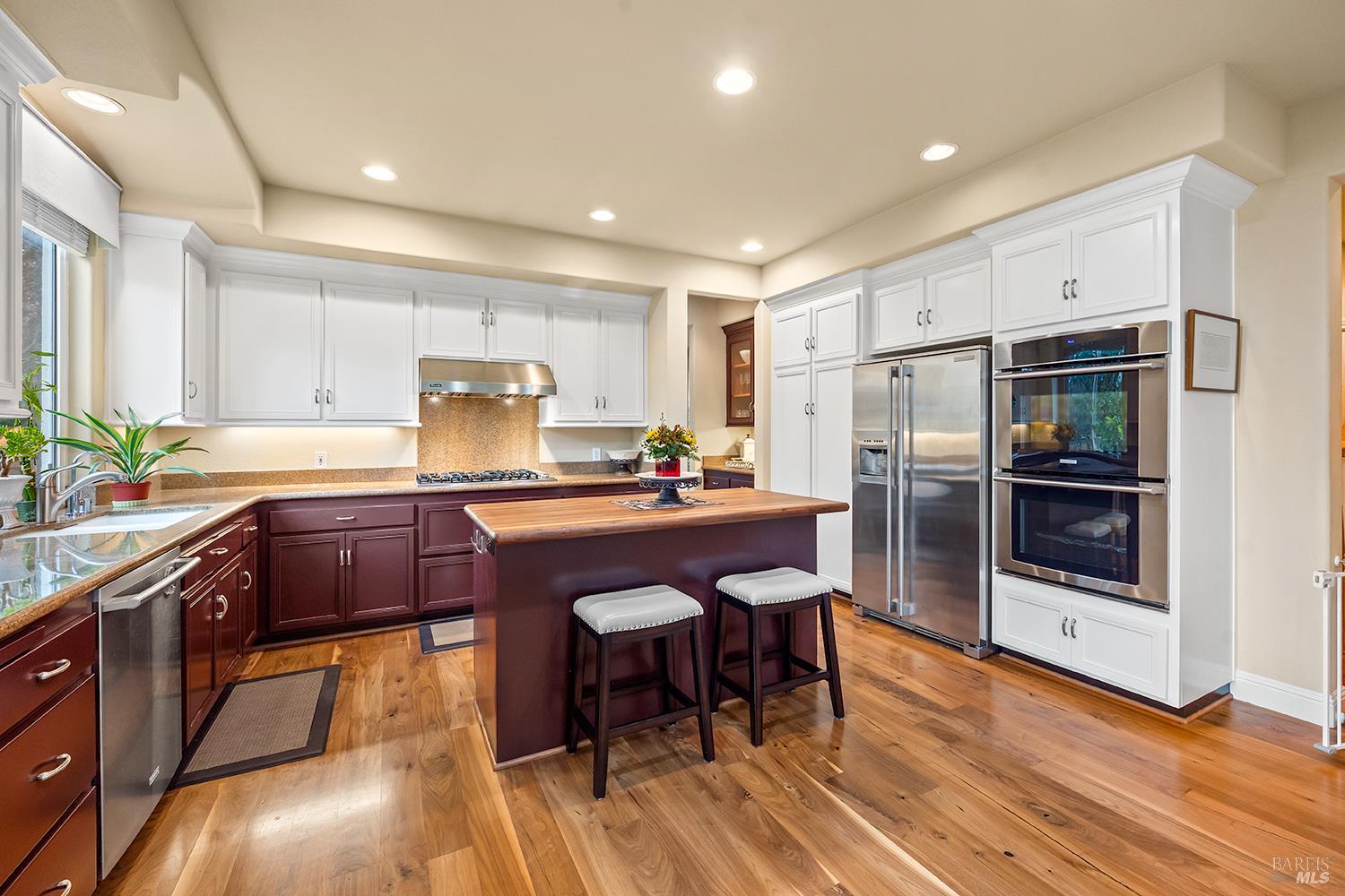 3696 Newbury Court Santa Rosa, CA 95404 - Photo 14 of 59 a kitchen with stainless steel appliances granite countertop a refrigerator a sink a stove a dining table and chairs