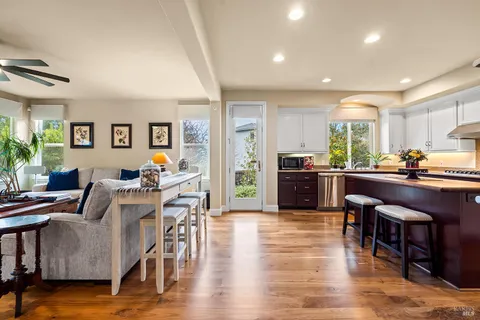 a living room with furniture a table and a chandelier