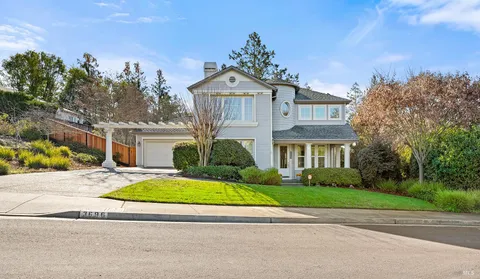 a view of a house with potted plants