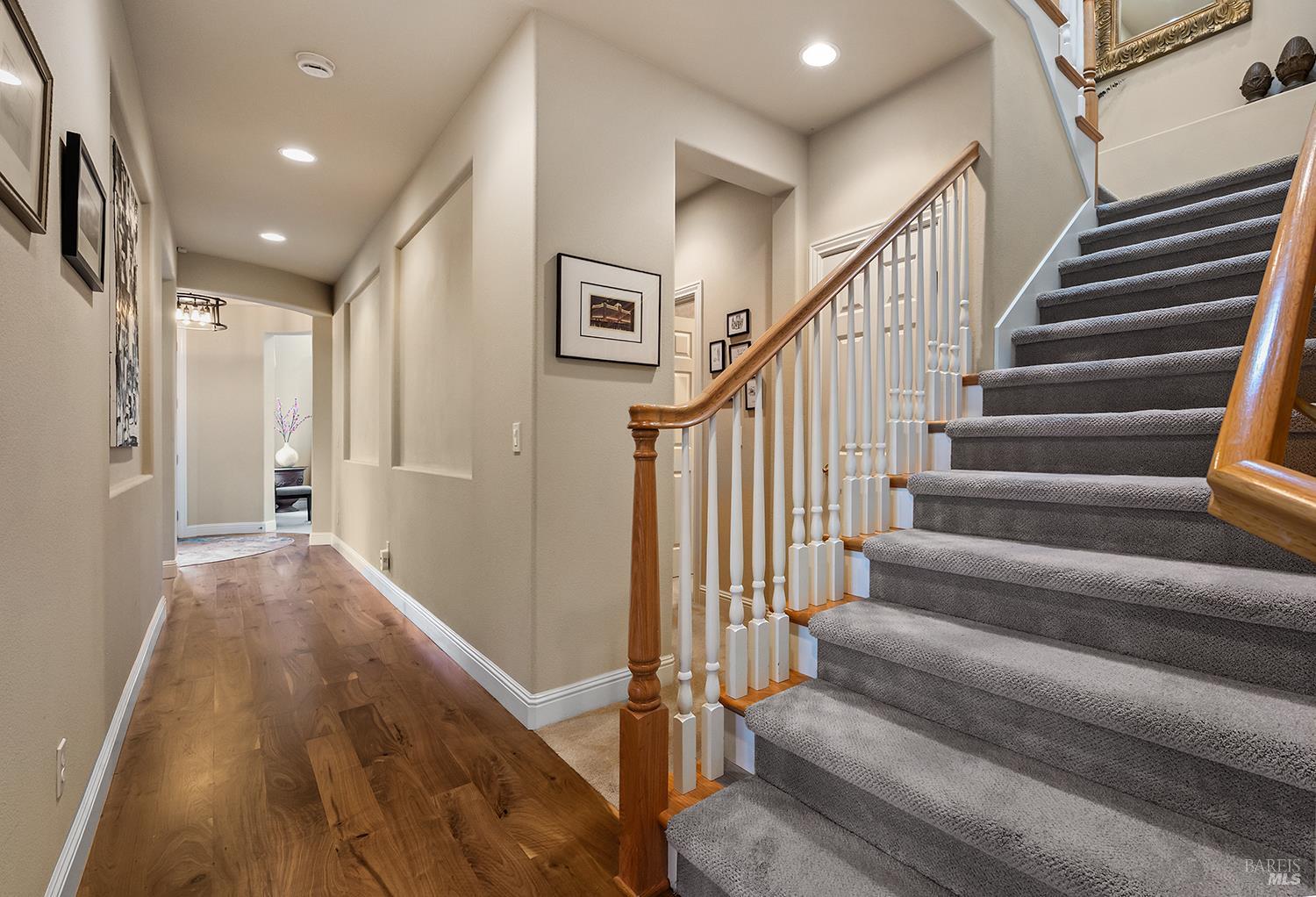 3696 Newbury Court Santa Rosa, CA 95404 - Photo 26 of 79 a view of staircase with lots of frames on wall and wooden floor