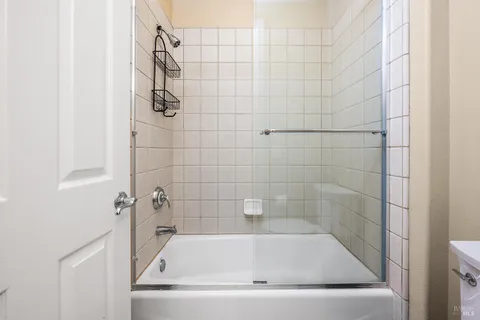 a patio with table and chairs and potted plants