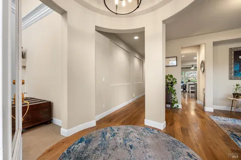a view of a livingroom with wooden floor and furniture