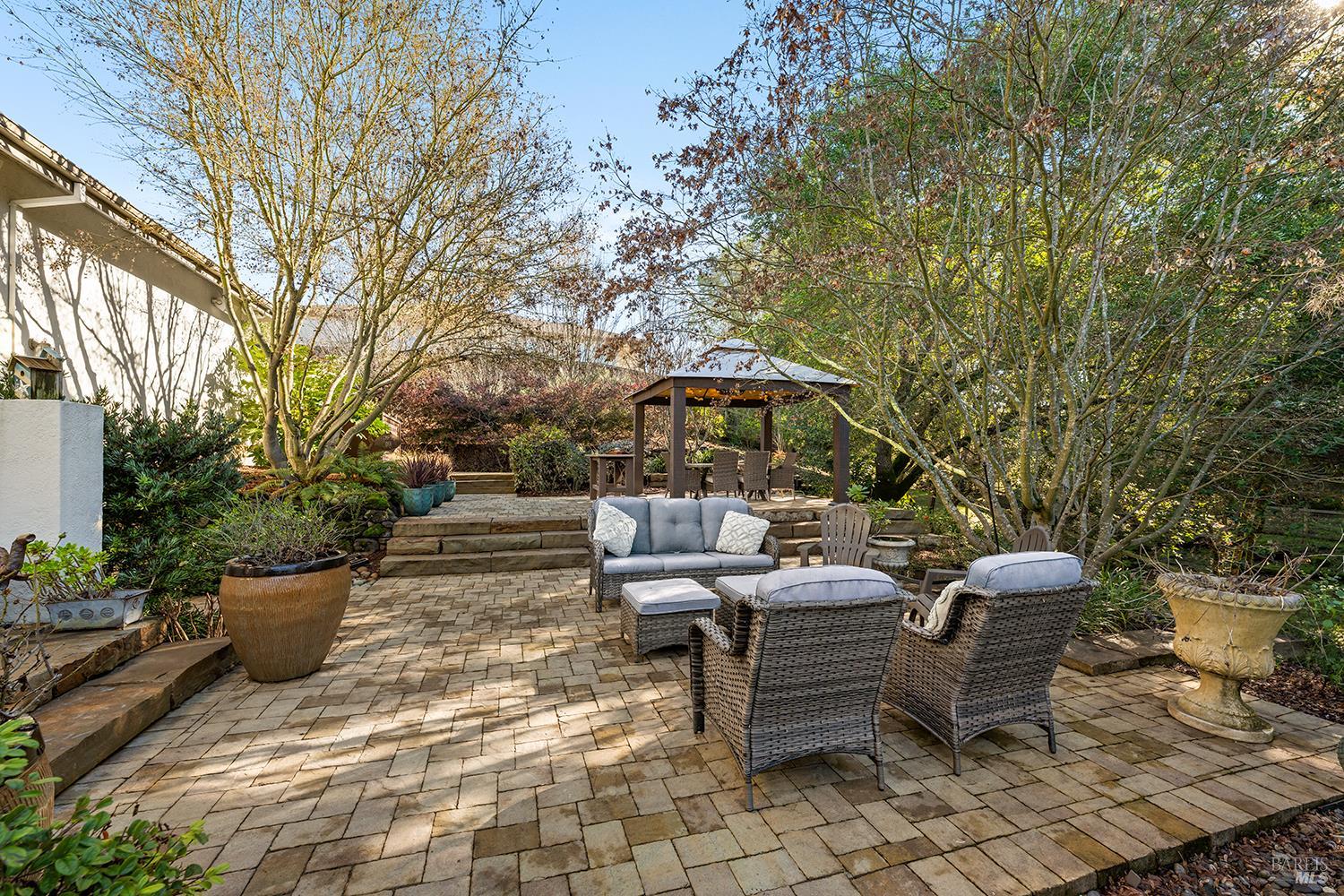 3696 Newbury Court Santa Rosa, CA 95404 - Photo 50 of 59 a view of a patio with table and chairs potted plants with wooden fence