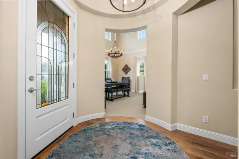 a dining room with furniture window and wooden floor