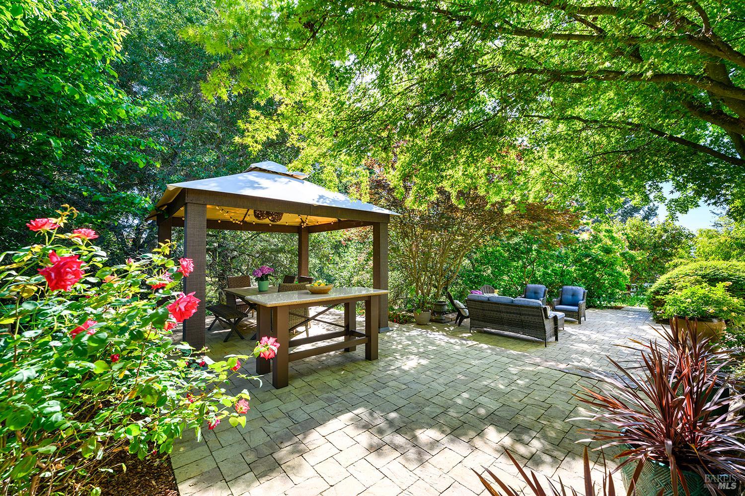 3696 Newbury Court Santa Rosa, CA 95404 - Photo 51 of 79 a backyard of a house with table and chairs under an umbrella