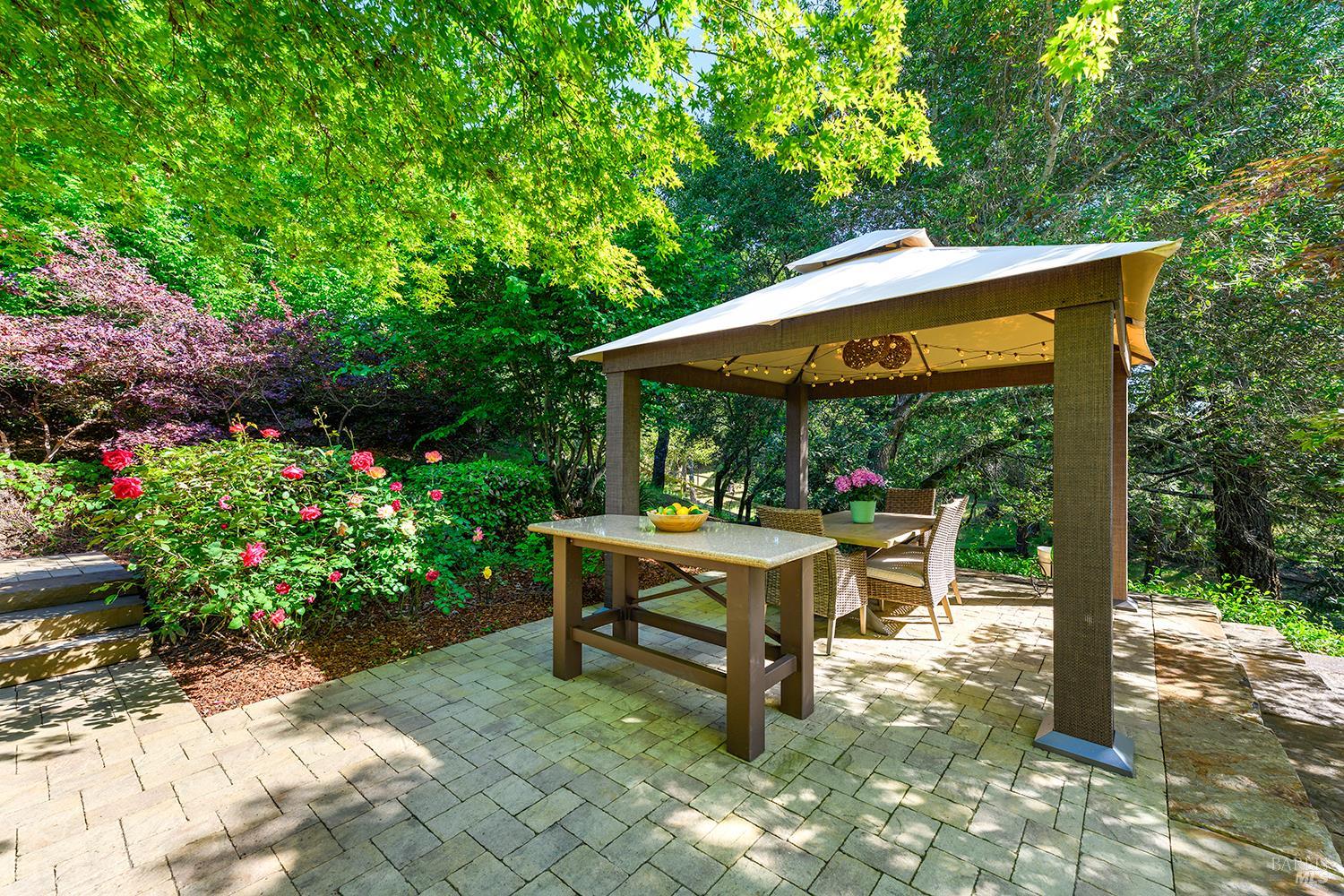 3696 Newbury Court Santa Rosa, CA 95404 - Photo 61 of 79 a backyard of a house with table and chairs under an umbrella