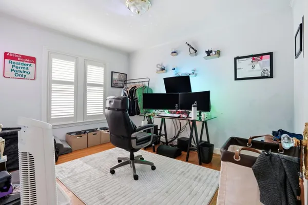a view of a workspace with furniture and a window