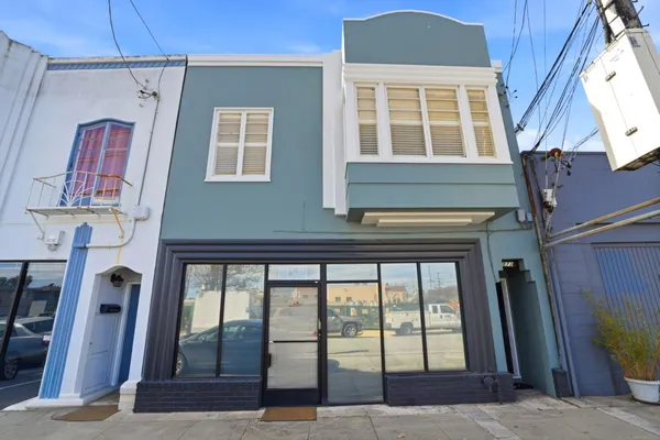 a front view of a house with a floor to ceiling window