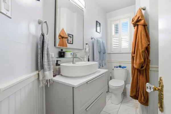 a bathroom with a toilet sink and mirror