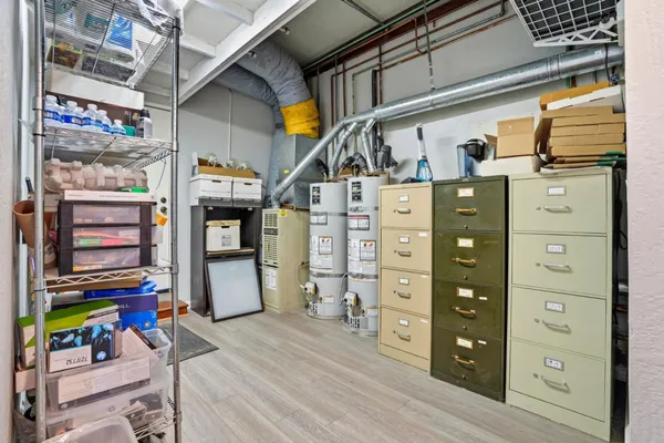 a kitchen with cabinets and wooden floor