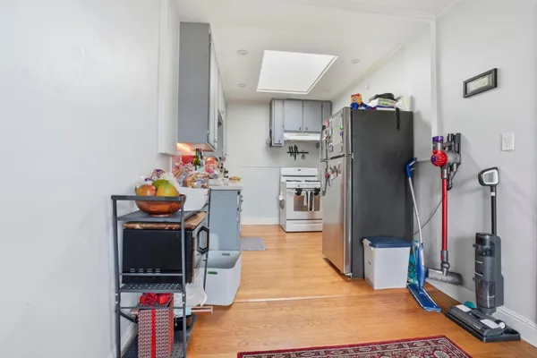 a view of a kitchen with fridge and workspace