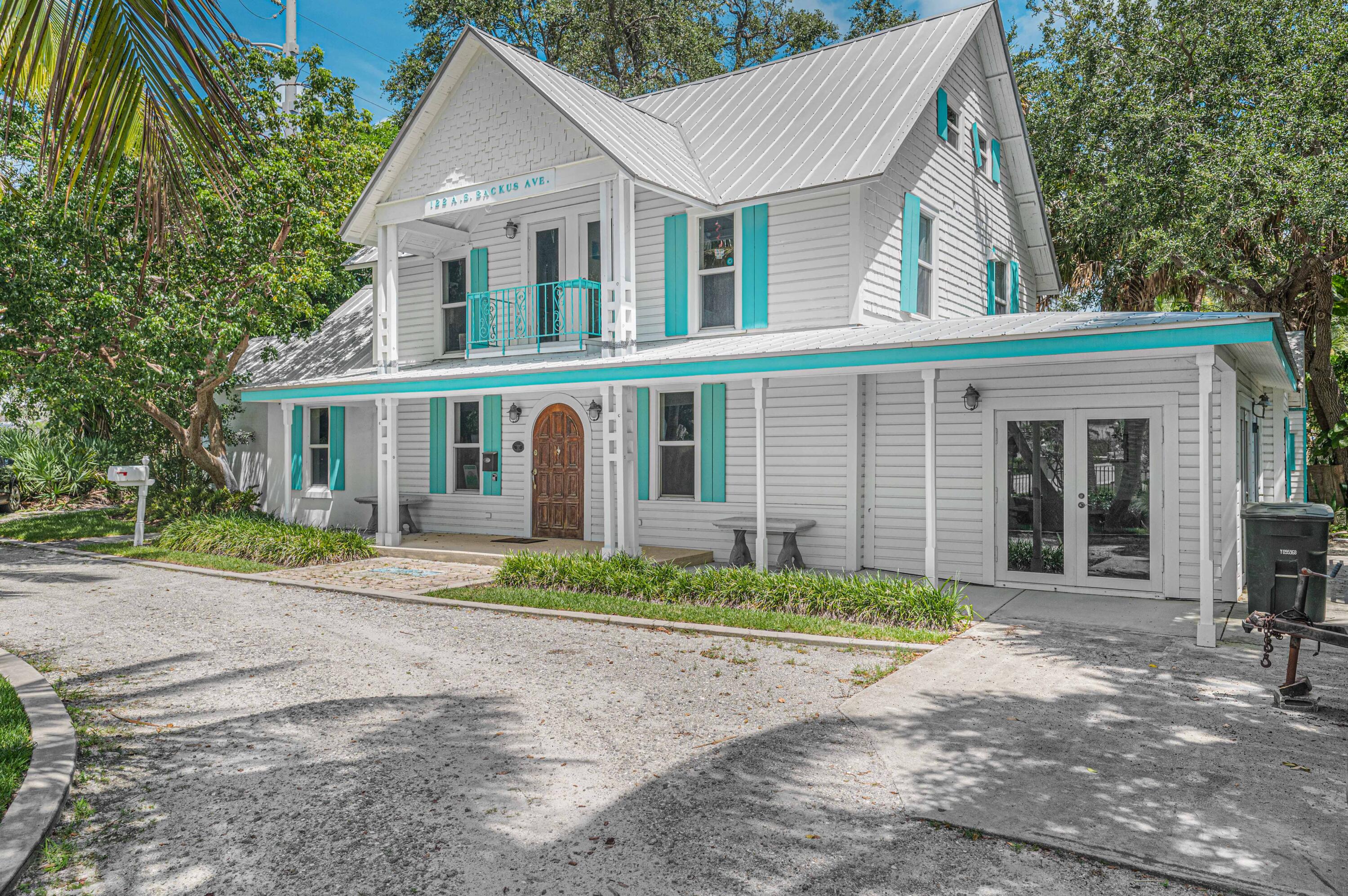 135 Kings Lane Fort Pierce, FL 34950 - Photo 43 of 67 a front view of a house with a garden and outdoor seating