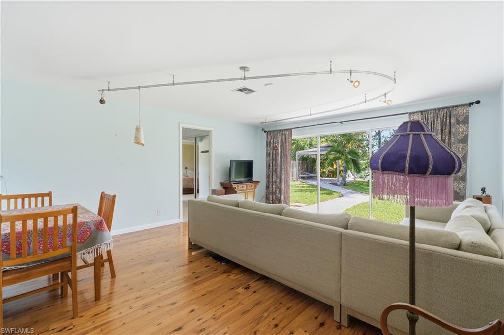 1316 Rordon Avenue Naples, FL 34103 - Photo 15 of 38 Open living area featuring wood-finish flooring, light blue wall tones, and recessed lighting on a curved track