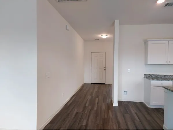 a view of a room with wooden floor and a sink