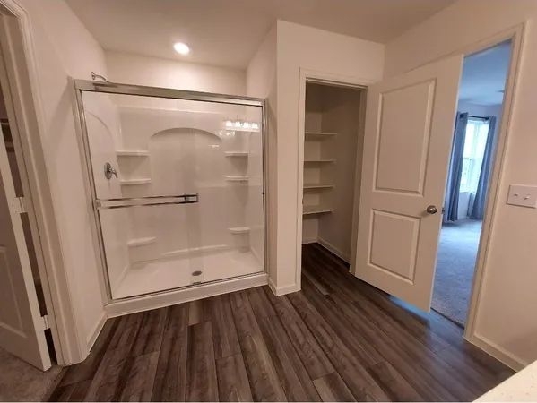 a bathroom with a glass door shower