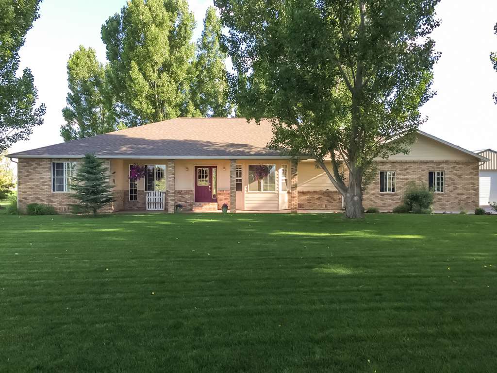 1677 L Road Fruita, CO 81521 - Photo 1 of 42 a front view of a house with a garden