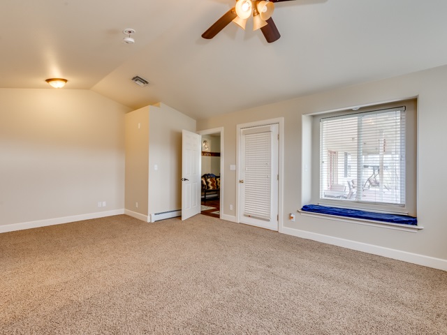 1677 L Road Fruita, CO 81521 - Photo 25 of 42 an empty room with chandelier fan and windows