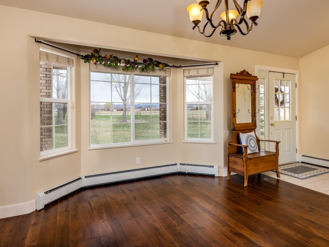 1677 L Road Fruita, CO 81521 - Photo 7 of 42 a view of an empty room with wooden floor and a window