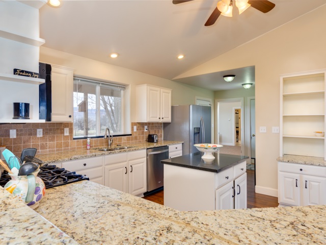1677 L Road Fruita, CO 81521 - Photo 10 of 42 a kitchen with stainless steel appliances kitchen island granite countertop a sink stove and refrigerator