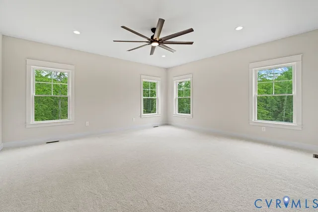 a view of a livingroom with a ceiling fan and window