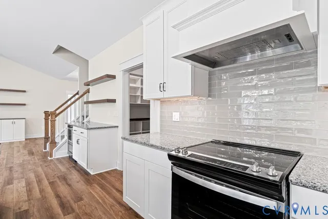 a kitchen with wooden floors and appliances