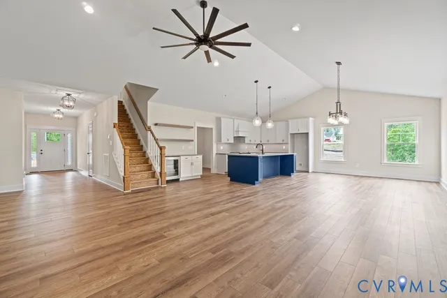 a view of empty room with wooden floor and window