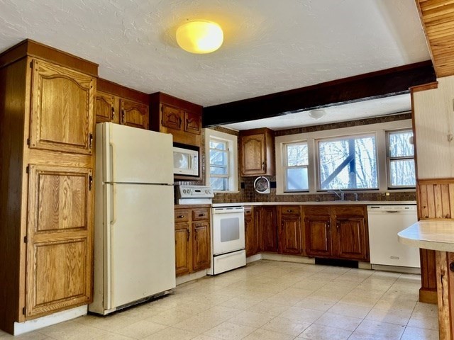 36 Summit Street Framingham, MA 01702 - Photo 5 of 24 a kitchen with stainless steel appliances granite countertop a refrigerator a stove and a sink with large cabinets