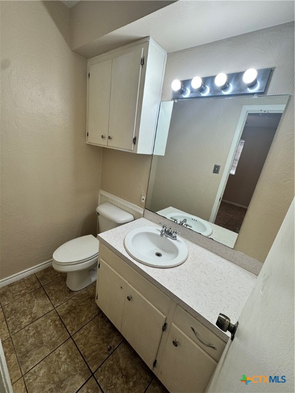 4602 Dahlia Lane Victoria, TX 77904 - Photo 11 of 16 a bathroom with a toilet sink and mirror