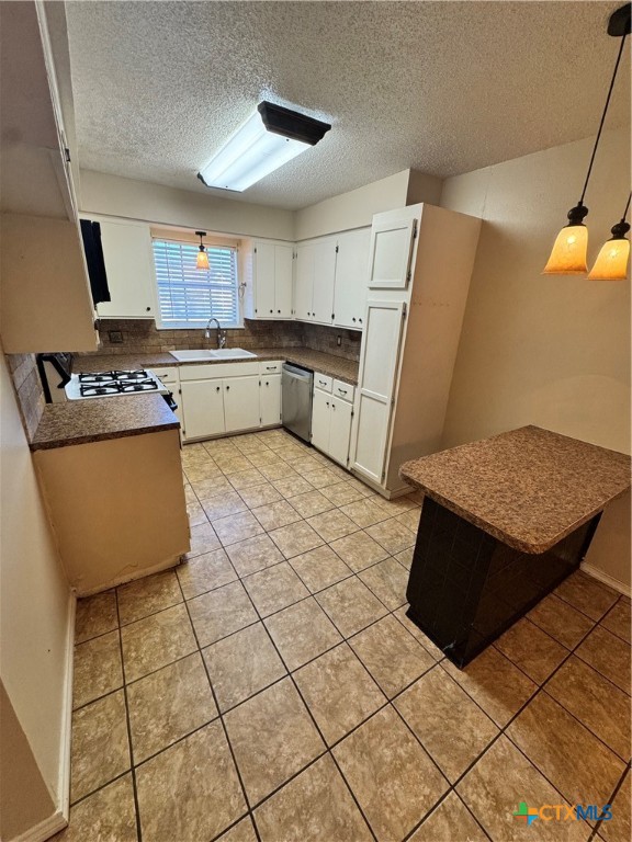 4602 Dahlia Lane Victoria, TX 77904 - Photo 6 of 16 a kitchen with stainless steel appliances a stove a sink and a refrigerator