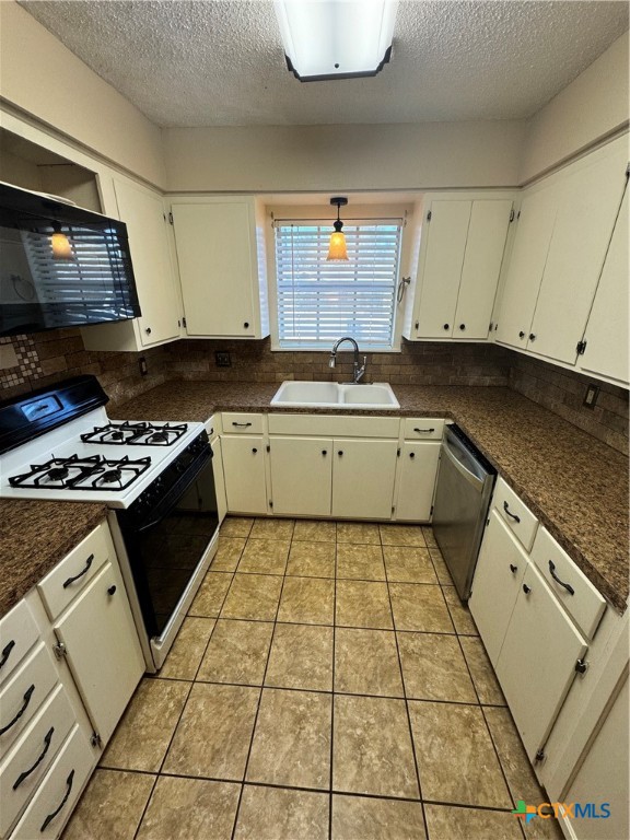 4602 Dahlia Lane Victoria, TX 77904 - Photo 7 of 16 a kitchen with stainless steel appliances granite countertop a stove a sink and a microwave