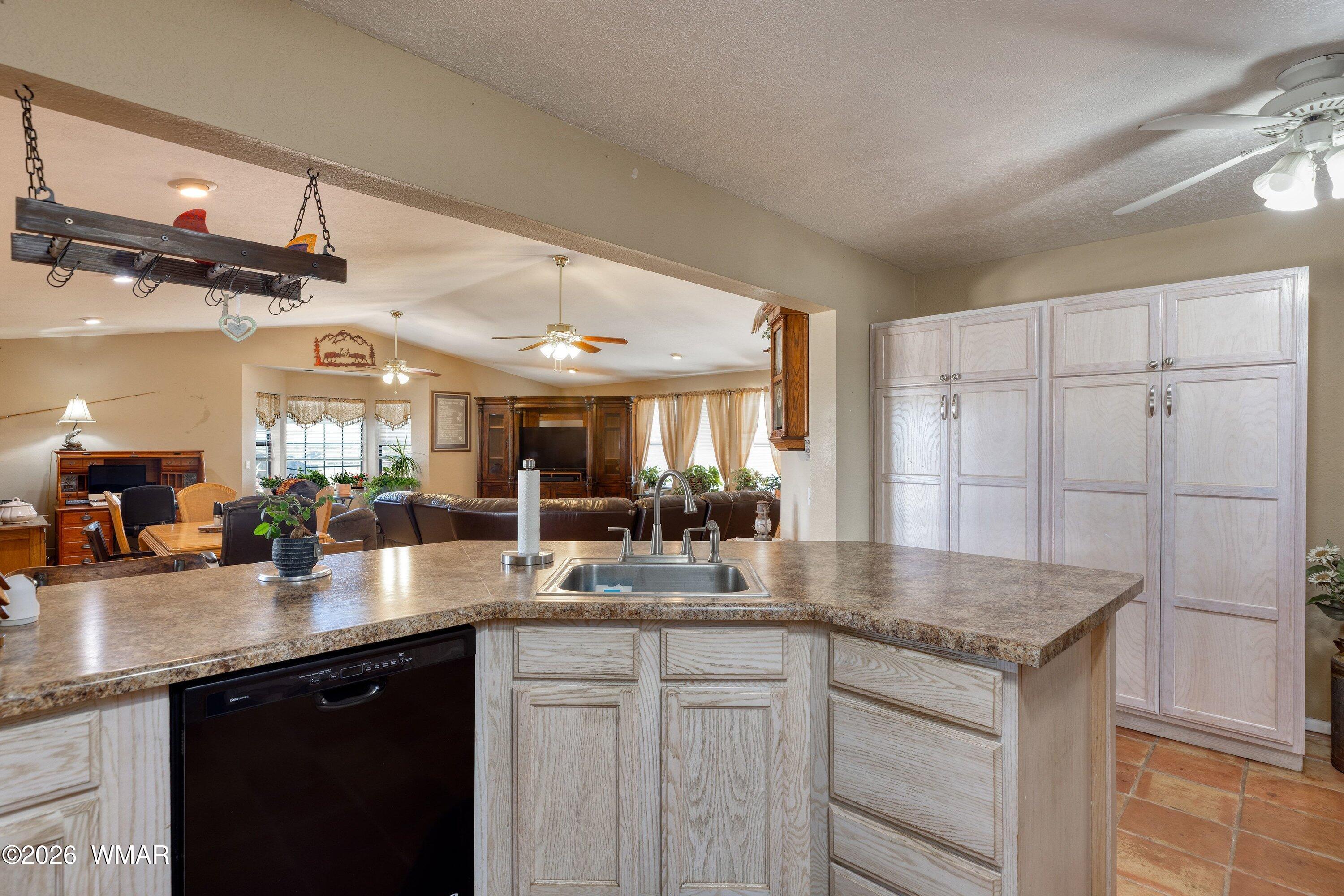1114 Ranch Road Taylor, AZ 85939 - Photo 14 of 32 a kitchen with granite countertop a sink stainless steel appliances and cabinets