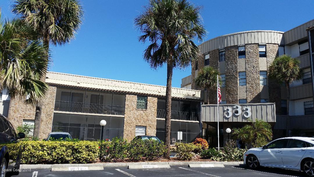 a front view of a building with tree s