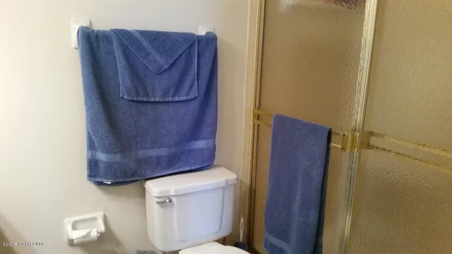 a wooden door in a bathroom