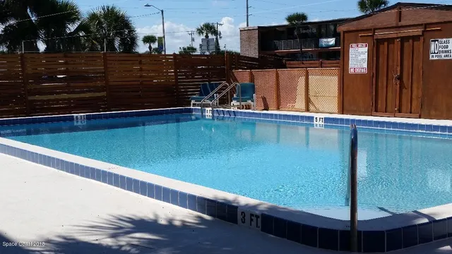 a view of swimming pool with outdoor seating and plants