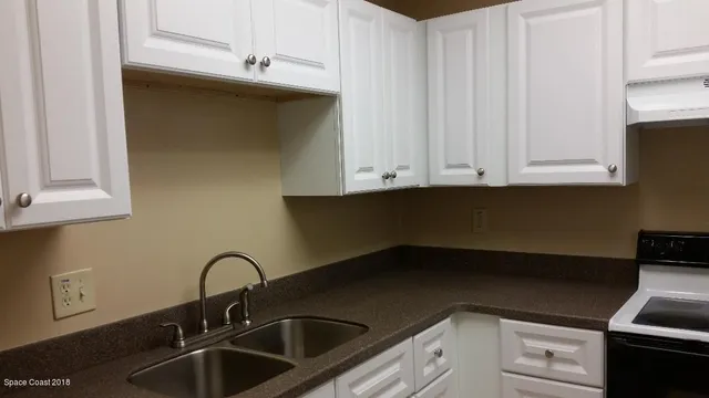 a kitchen with a sink and cabinets