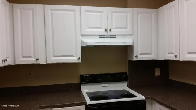 a room with a sink cabinets and utility room