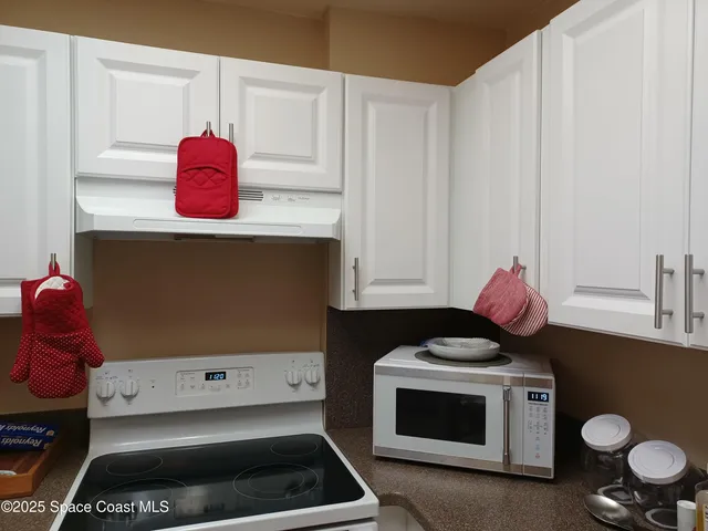 a kitchen with a stove and cabinets