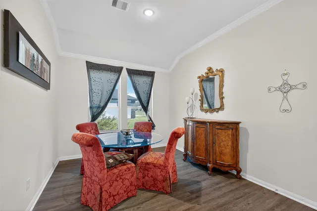 a view of a dining room with furniture and wooden floor