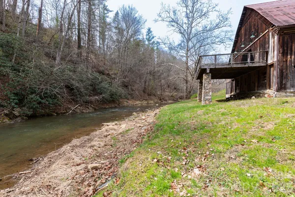 a view of a swimming pool with a yard and trees