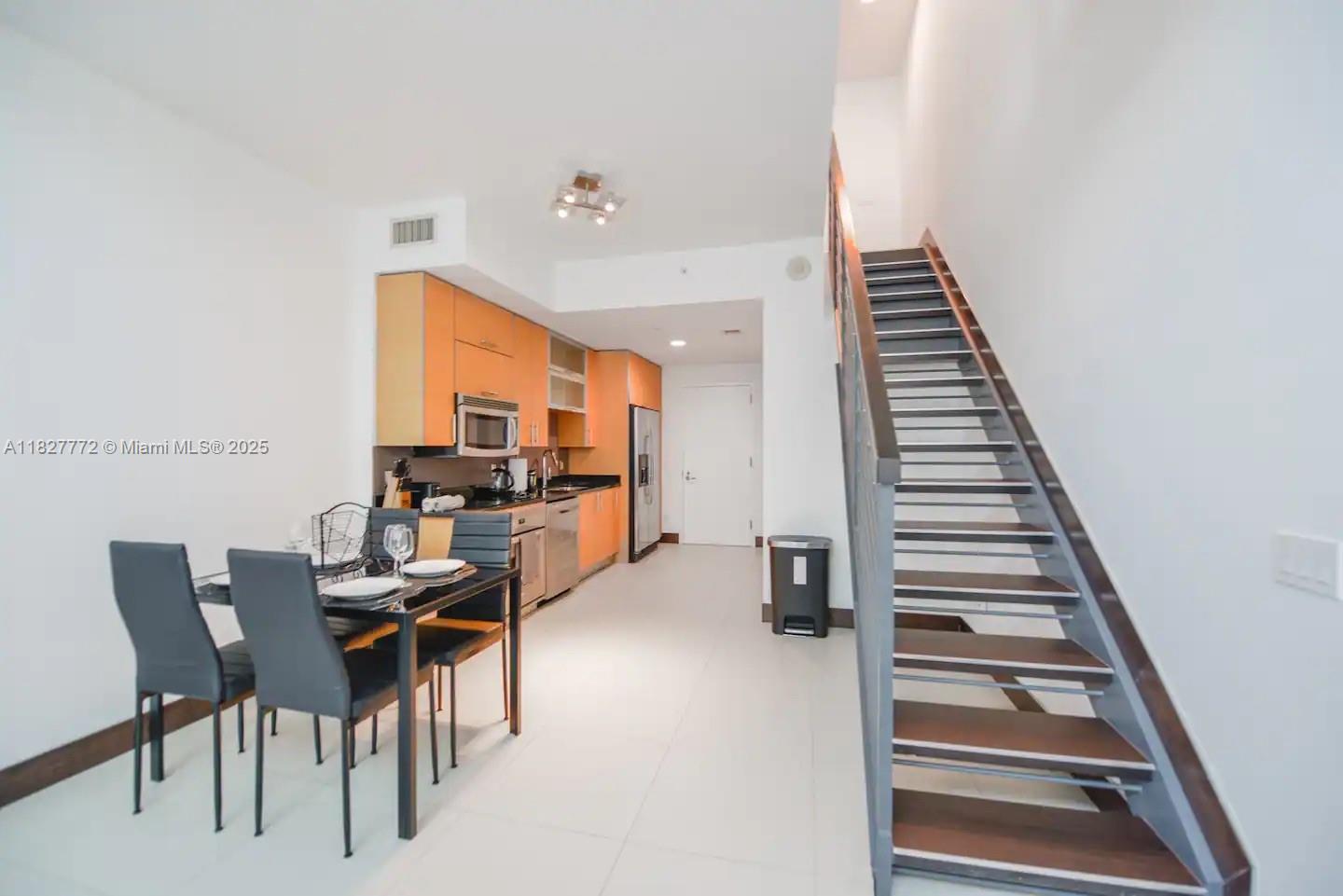 Brickell Miami, FL 33130 - Photo 12 of 26 a view of a dining room with furniture and stairs