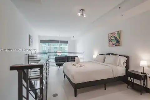 Brickell Miami, FL 33130 - Photo 16 of 26 a bedroom with a bed a table and chairs