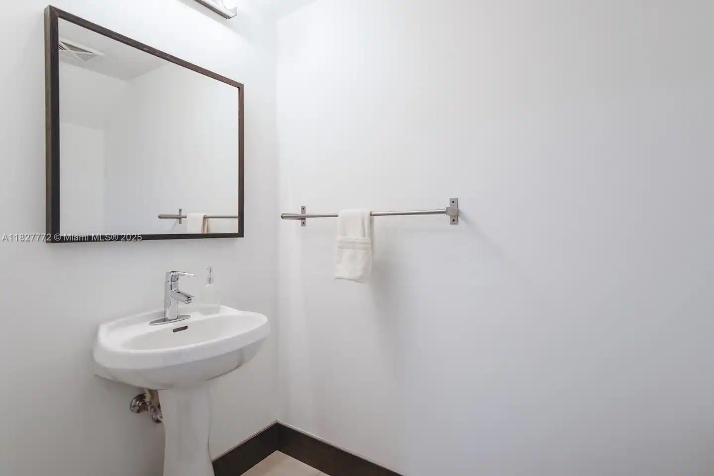 Brickell Miami, FL 33130 - Photo 21 of 26 a bathroom with a sink and a mirror