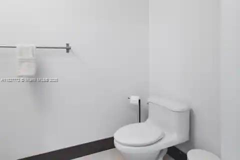 Brickell Miami, FL 33130 - Photo 22 of 26 a white toilet sitting next to a shower