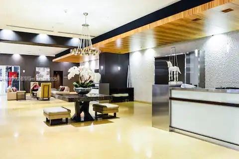 Brickell Miami, FL 33130 - Photo 26 of 26 a living room with furniture a flat screen tv and kitchen view